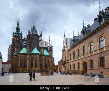 Prag, Tschechische Republik - 24. November 2010: Touristen spazieren über den Dritten Innenhof mit der gotischen Architektur des Veitsdoms im Hintergrund i Stockfoto