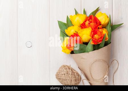 Bunte Tulpen über Holztisch Stockfoto