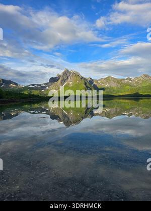 Majestätische Berglandschaft, die sich an einem ruhigen Sommertag in den ruhigen Gewässern Norwegens spiegelt Stockfoto