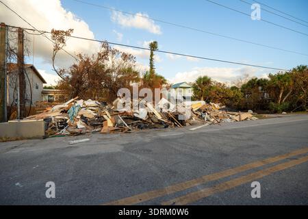 Trümmerhaufen auf der Straßenseite nach Hurrikan Milton auf der Manasota Key Road in Florida. Müll aus schwer beschädigten Häusern nach Sturmflut Stockfoto