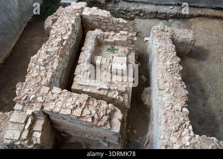 Blick von oben auf ein ausgegrabenes Mauerwerk und umliegende Mauern an der archäologischen Stätte Villa Romana de Fuente Alamo, Puente Genil, Cordoba, Spanien. Stockfoto