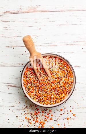 Mischung aus rohem Bio-Getreide. Linsen und Quinoa (weiß und rot) in einer Schüssel und einer Holzlöffel. Leckere und gesunde Ernährung. Protei Stockfoto