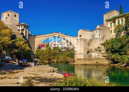Mostar, Bosnien und Herzegowina - 15. Oktober 2025: Touristen besuchen die historische Stari Most (Alte Brücke) über den Fluss Neretva. Berühmte osmanische Architektur Stockfoto