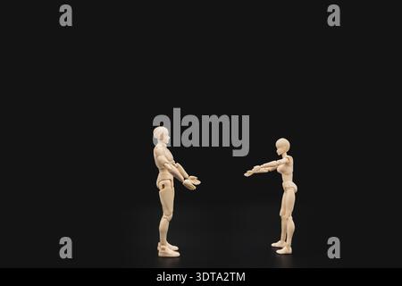Zwei Plastikpuppen versuchen, sich gegenseitig auf schwarzem Hintergrund zu umarmen, konzeptuelle Kunst menschlicher Verbindung und Intimität. Stockfoto