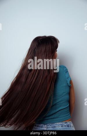Seitliches Porträt einer jungen Haarfrau isoliert auf neutralem Hintergrund. Stockfoto