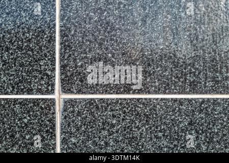 Das Licht wird an der glänzenden, gekachelten Außenwand eines Gebäudes reflektiert Stockfoto
