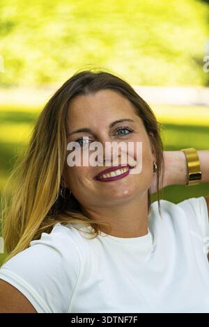 Hübsche blonde junge Dame mit grünen Augen, die in die Kamera schauen Stockfoto