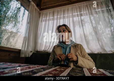Eine junge Frau in einer gemütlichen Hütte Stockfoto
