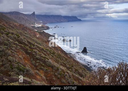 Breiter erhöhter Blick auf die Küste von Anaga mit Playa de Benijo, dem Dorf Almáciga und vulkanischen Gesteinssteinen entlang der zerklüfteten Nordküste von Stockfoto