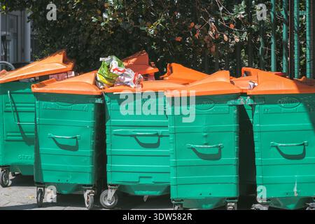 Überfüllte große Mülltonnen auf der Straße von Stratford in London, Großbritannien Stockfoto