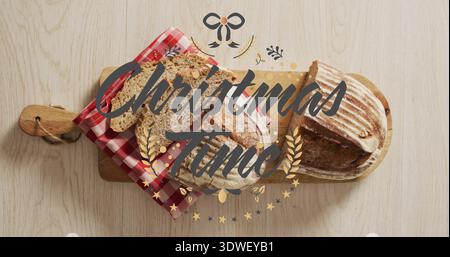 Mit zwei Sauerteiglaiben, einer teilweise auf Paddleboard geschnitten zu Hause Weihnachtszeit Overlay Stockfoto