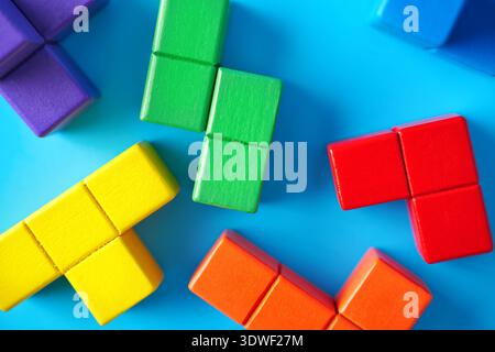 Bunte Puzzleteile liegen auf einem hellblauen Hintergrund und symbolisieren Autismusbewusstsein und geistige Gesundheit. Sie repräsentieren kognitive Strategien Stockfoto