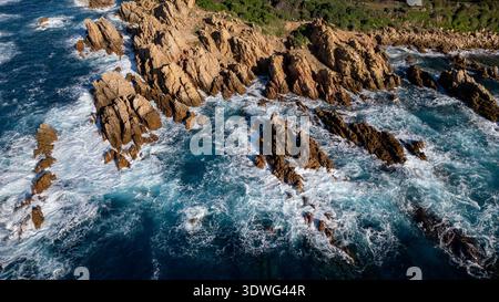 Ein spektakuläres Küstenpanorama von Nordsardinien, das die berühmten roten Granitklippen der Costa Paradiso zeigt, die in das türkisfarbene und transparente Wasser eintauchen Stockfoto