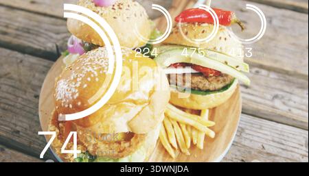 Drei Schieberegler auf rundem Holzbrett auf rustikaler Tischplatte mit Pommes Frites und HUD-Überzügen Stockfoto