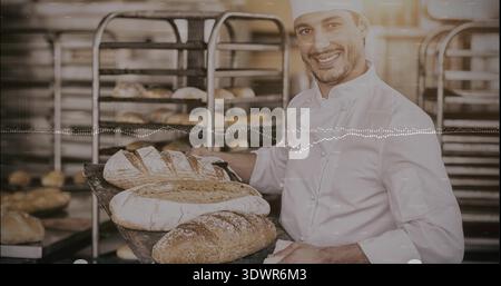 Der Bäcker trägt einen Kochmantel und Hut, der Sauerteigbrotschalen in der Bäckerei trägt, Kopierraum Stockfoto