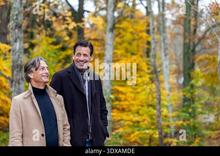 Glückliche ältere Männer verbringen Freizeit beim Spaziergang durch den Herbstwald Stockfoto