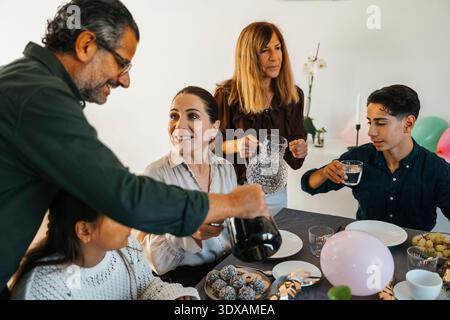 Glückliche Familie, die zu Hause Geburtstag feiert Stockfoto