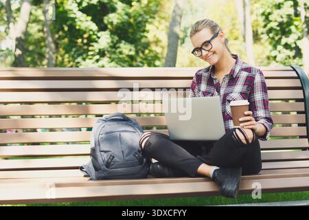 Sammlung von Momenten, die eine Frau zeigen, die an einem Laptop arbeitet, während sie sich im Park entspannt Stockfoto