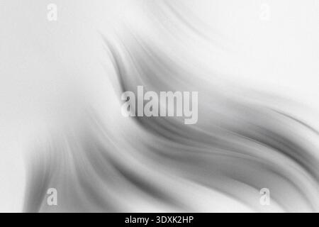 Ein verschwommenes Schwarzweißbild mit einer Hand, die die Finger vor einem weichen weißen Hintergrund gestreckt hat Stockfoto