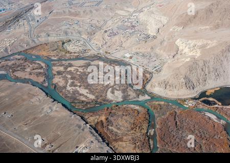 Aus der Vogelperspektive des Indus, der durch die trockene Landschaft von Leh fließt, zeigt seine geflochtenen Kanäle und umliegenden Siedlungen. Stockfoto