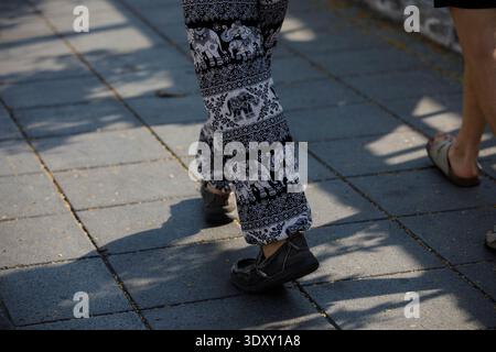 Mann in Elefantenhosen und schwarzen Turnschuhen, Reisende entdecken ein neues Reiseziel, Hochwinkelblick Stockfoto