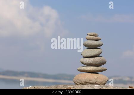 Steinstapel am Strand vor blauem Himmel Stockfoto