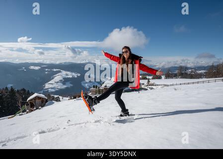Frau in roter Jacke auf verschneiten Pisten in den Dolomiten, Italien Stockfoto