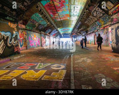 Die Betonwände der Leake Street Arches in Waterloo, London, wurden im März 2026 mit einer lebendigen Ausstellung von Graffiti und städtischen Wandgemälden bedeckt. Dieser 300 Meter lange unterirdische Durchgang unter der Waterloo Station ist nach dem Cans Festival 2008 weltweit als „Banksy Tunnel“ bekannt und ist der größte legale Straßenkunstplatz der Stadt. Stockfoto