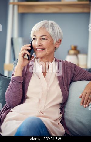 Telefonanruf, glückliche und ältere Frau auf dem Sofa für Gespräche, Gespräche und soziale Netzwerke. Ruhestand, Heim und ältere Person auf Smartphone für Stockfoto