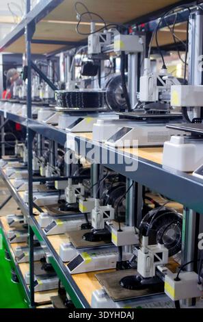 Viele 3D-Drucker aus nächster Nähe. Verarbeiten Sie den 3D-Drucker des Druckobjekts aus geschmolzenem schwarzem Kunststoff. 3D-Drucker, der ein Modell erstellt, indem flüssiger Kunststoff aus dem Extruder des Druckers fließt. 3D-Drucktechnologie Stockfoto
