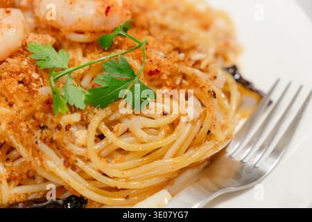 Shrimps-aglio und olio-Pasta mit einer silbernen Gabel Stockfoto