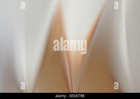 Eine abstrakte Nahansicht einer strukturierten Oberfläche, möglicherweise Stoff oder Papier, mit subtilen Falten und Farbvariationen zwischen Hellbeige/Gold und Stockfoto