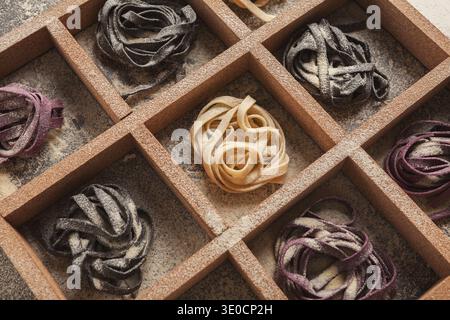 Sammlung von Nudelsorten, die in einem Rasterformat mit verschiedenen Farben und Texturen angeordnet sind Stockfoto