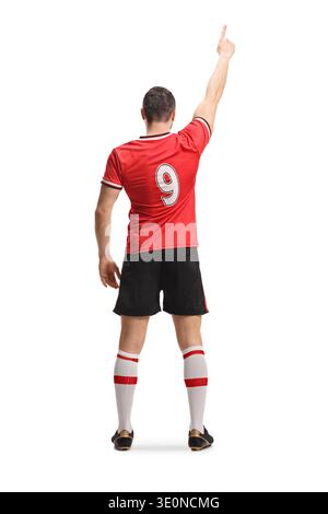 Rückansicht eines Fußballspielers in einem roten Trikot, der isoliert auf weißem Hintergrund steht und zeigt Stockfoto