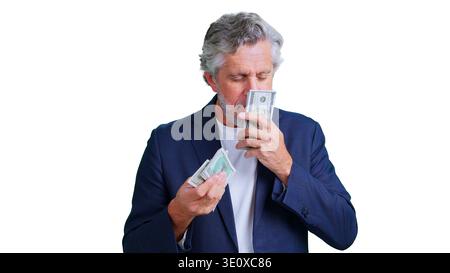 Reifer Geschäftsmann riecht Geld und feiert finanziellen Erfolg Stockfoto