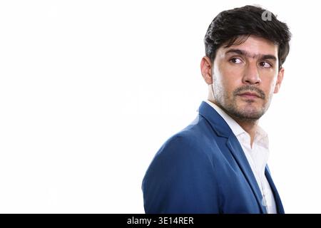 Studio shot der jungen Persischen Geschäftsmann denken beim Blick zurück Stockfoto