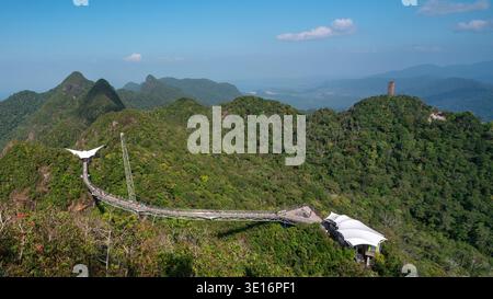Langkawi, Kedah/Malaysia – 20. Januar 2020: Die Langkawi Sky Bridge überspannt einen bewaldeten Bergkamm mit Besuchern auf dem Gehweg. Stockfoto