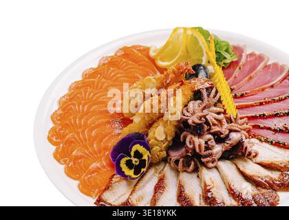 Eine wunderschön angeordnete Sashimi-Platte zeigt eine Vielzahl von frischen Meeresfrüchten, einschließlich Lachs, Thunfisch und Oktopus, garniert mit Gemüse und essbar Stockfoto