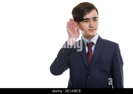 Studio-Aufnahme des jungen hübschen persischen Teenager-Geschäftsmann zuhören Stockfoto