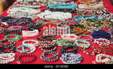 Bunte Armbänder und Halsketten auf rotem Tuch in Indien Stockfoto