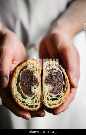Bäcker Mit Frisch Gebackenem Golden Babka Loaf. Großaufnahme Von Weicher, Flauschiger Babka Mit Glänzender Schokolade Stockfoto
