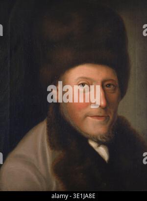 Dieses Ölgemälde aus dem 18. Jahrhundert, wahrscheinlich aus den 1780er Jahren, zeigt ein formelles Porträt von Isaac Jacob Gans. Der unbekannte Künstler hat ihn in einem scheinbar mit Pelz gefütterten Hut und Mantel mit sichtbaren Pinselstrichen und einem leicht geröteten Teint dargestellt, was auf einen lebendigen Charakter hindeutet. Stockfoto