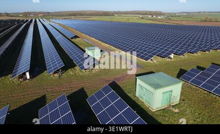 Luftaufnahme eines riesigen Solarparks, der sich unter klarem Himmel zum Horizont hin erstreckt und eine nachhaltige Zukunft verspricht, Retford, Großbritannien. Stockfoto