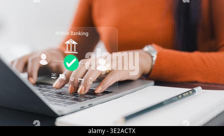 Sichere Online-Banking-Transaktion auf Laptop.digitaler Geldtransfer über Finanztechnologie.kontaktloses Bezahlen und E-Wallet-Konzept.Frau Hand mit Stockfoto
