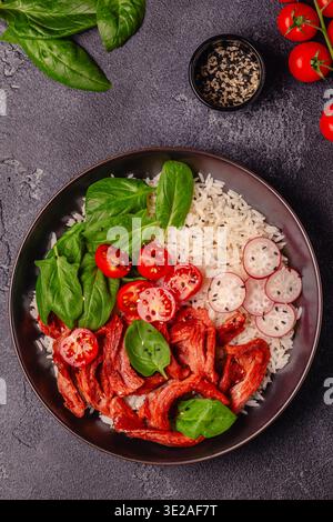 Schüssel mit veganem gebratenem Sojafleisch und Gemüse, serviert mit gekochtem Reis. Köstliche gesunde Ernährung Lebensmittel. Stockfoto