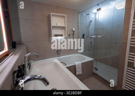 Modernes Hotelbad mit Wanne und Regendusche in Oberlech, Österreich Stockfoto