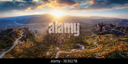 Panoramablick über den Sonnenuntergang auf das Tal von Meteora, Griechenland, mit den berühmten Klöstern und Kalabaka Stadt unten Stockfoto