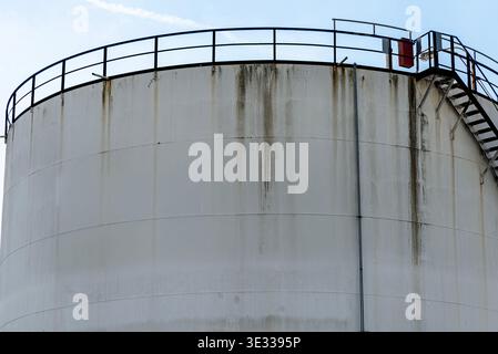 Großer industrieller Lagertank mit Geländern und Leiter in einer Kläranlage Stockfoto