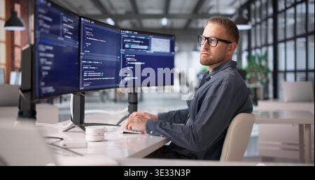 Dedizierter Softwareentwickler, Der Sich Auf Programmierung Und Problemlösung An Der Workstation Konzentriert Stockfoto