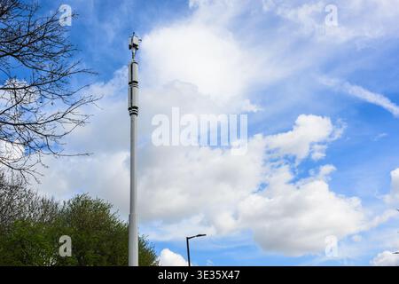 Nahaufnahme von 5G-Mobilfunkmast mit Antennen vor blauem Himmel, moderner Telekommunikationsinfrastruktur und drahtloser Netzwerktechnologie. Stockfoto